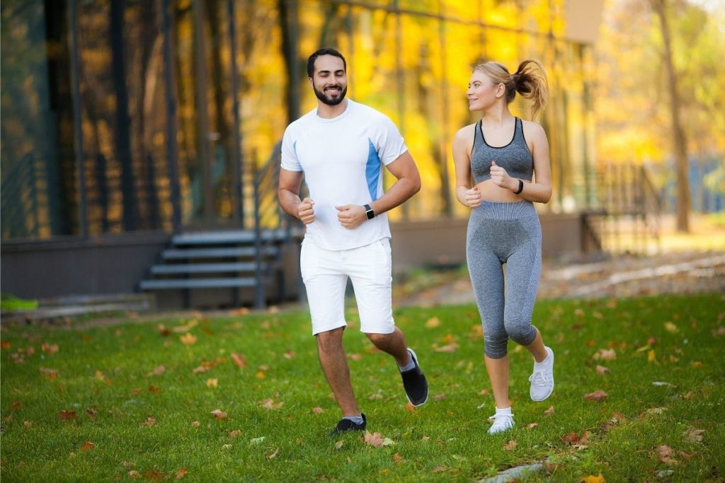Couple Jogging on Grass