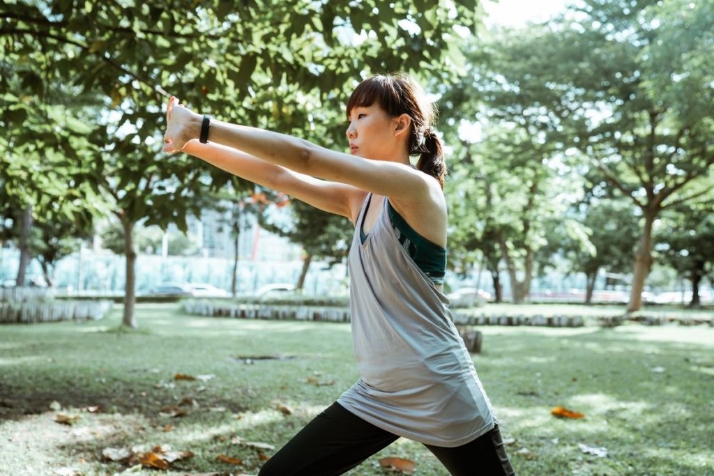 Woman Stretching in a Park
