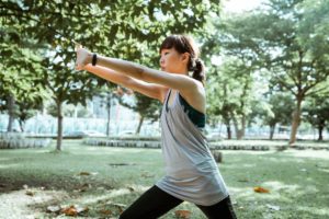 Woman Stretching in a Park